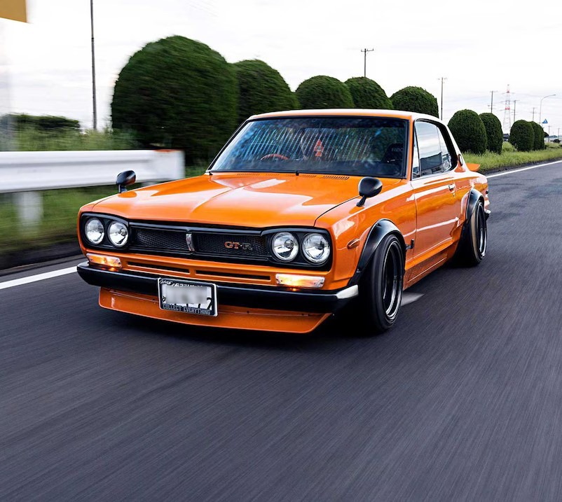 Image of an orange vehicle moving on the street.